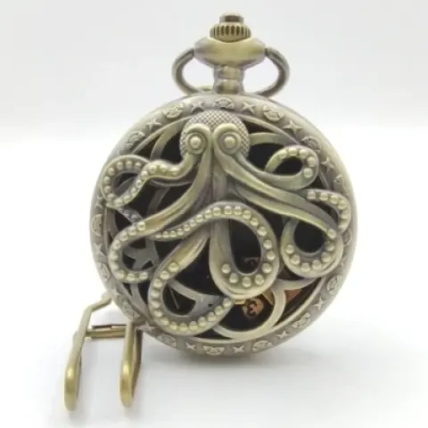 Mini-dice in decorative flip-case: hollow golden kraken in a black suedecloth pouch