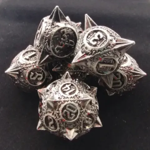 Spiky metal dice:bloodied silver in a black suedecloth bag